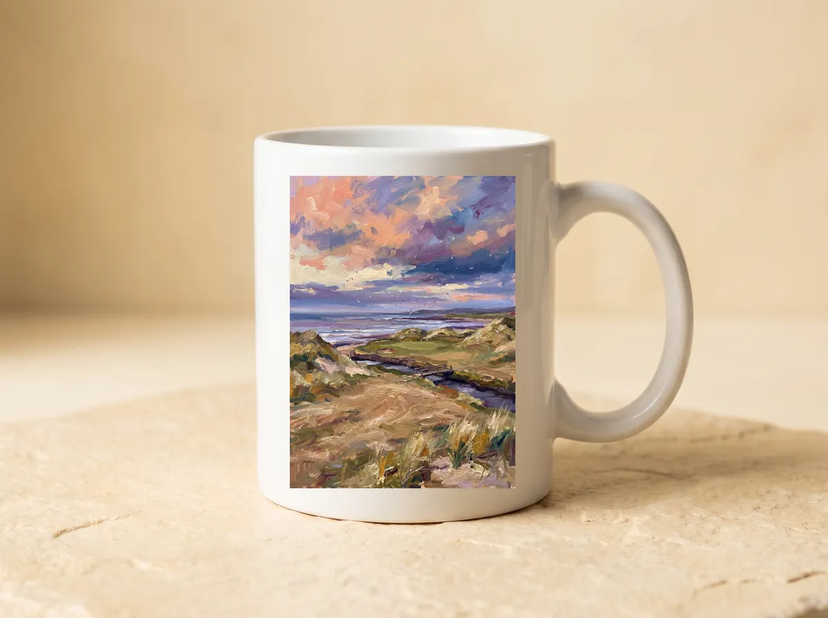 Links at Dusk printed on a white mug, the big lilac sky, the sea and the sandy path all in view.